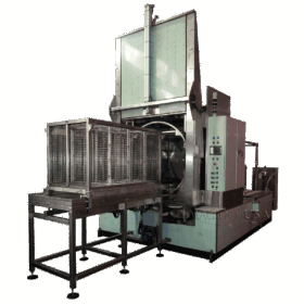 corner view front open Platinum series P1500 rotary immersion parts washer with wash cage resting out front on loading table.